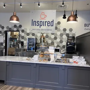 a coffee shop counter with a variety of items
