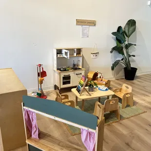 a play area with wooden furniture