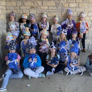 Girl Scouts making fleece hats and scarves for themselves and children in need.