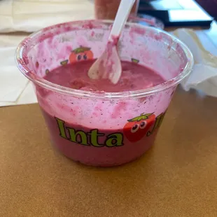 a plastic cup with a spoon in it