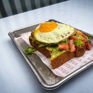 a sandwich with an egg and avocado