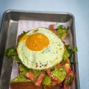 a breakfast sandwich with an egg