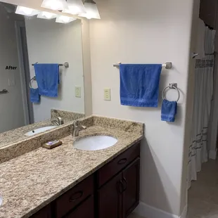 a bathroom with two sinks and a shower