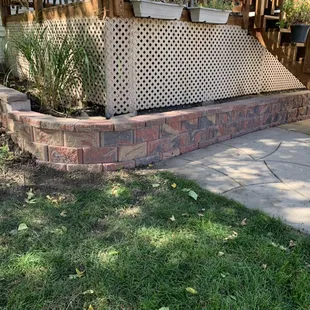a patio with a retaining wall