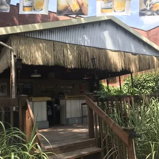 a tiki hut in the background