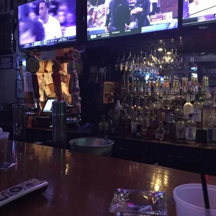a bar with several televisions in the background