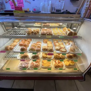 Display case of all the different types of buns and pastries available