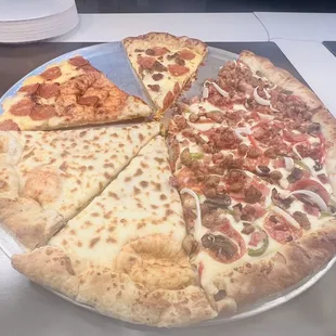 a variety of pizzas on a table