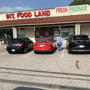 three cars parked in front of a store