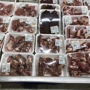 a display of meat in plastic containers