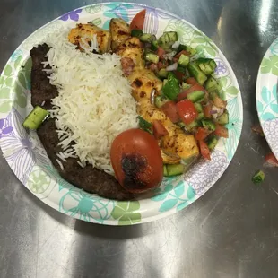Chicken kabob and koobideh with rice and tomato cucumber salad.