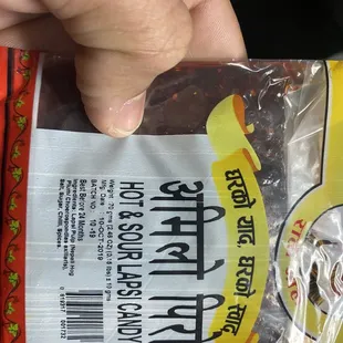 a hand holding a package of food