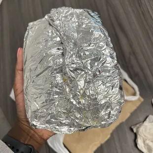 a person holding a piece of tin foil