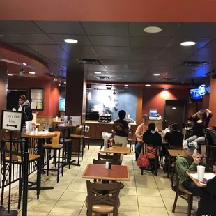 ows people sitting at tables in a restaurant