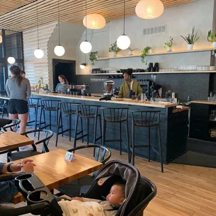 a baby in a stroller in a cafe