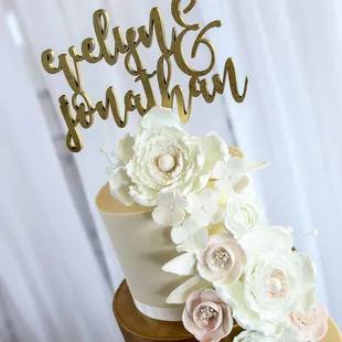 a wedding cake decorated with flowers