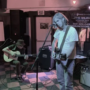 a man playing guitar and singing