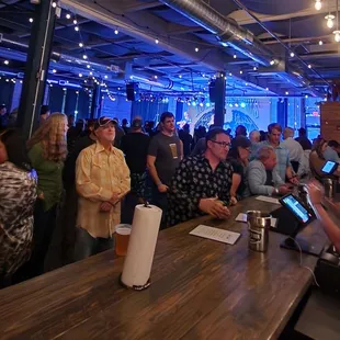 a crowd of people at a bar