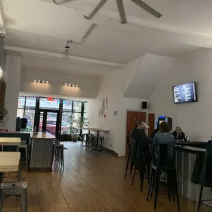 people sitting at tables in a bar
