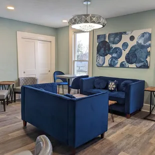 a living room with blue couches