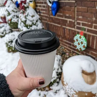 a person holding a cup of coffee