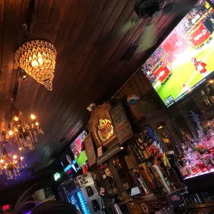 a bar with a chandelier hanging from the ceiling