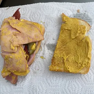 This one side of half the sandwich. This overflow of mustard occurs on both sides.