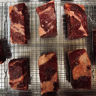 Boneless Short Ribs cut up and on a rack for a dry brine.