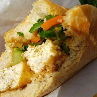 Interior of tofu banh mi ($4.50), vegan by omitting mayo. Meh. Mealy bread, flavorless tofu.