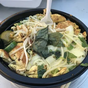 a bowl of food with chopsticks in it