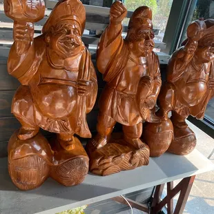 a group of wood statues