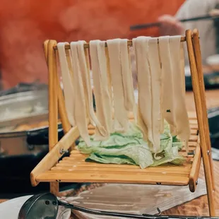 a plate of noodles on a bamboo stand