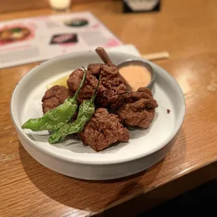 Karaage with burnt tasting difficult to bite through breading. It looks better than it tastes.