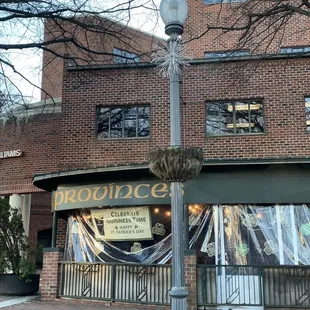 a street light in front of a brick building