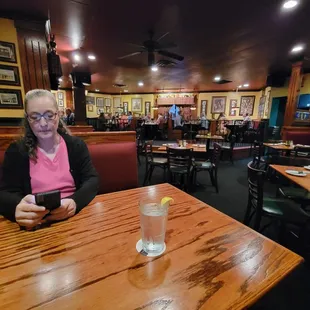 My wife, sitting at our booth.