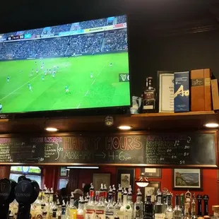 The bar and big screen with soccer on.
