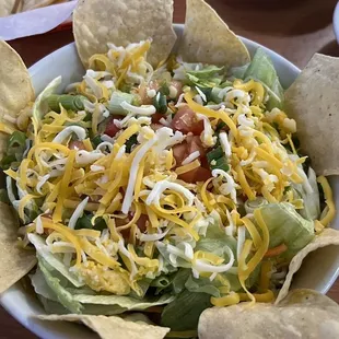Salad no shell with refried beans and green chili. Fresh and delicious