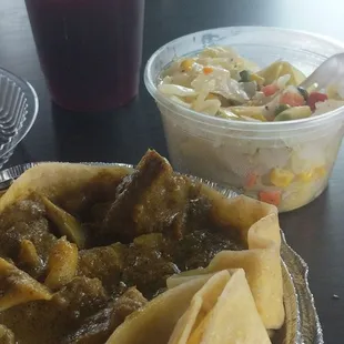 Curry goat with roti, cabbage, sorrel drink