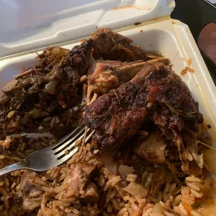 a plate of food with meat and rice
