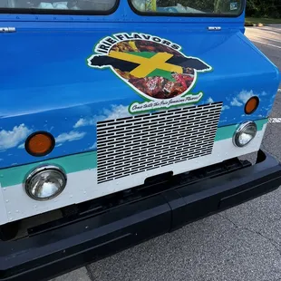 a blue food truck parked on the side of the road