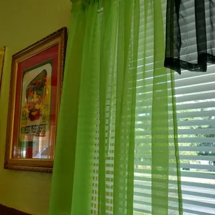 a window with green curtains