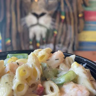 a bowl of pasta with shrimp and vegetables