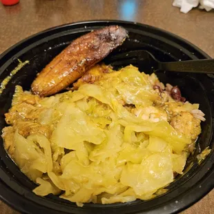 Curry Chicken, plantain's and cabbage, under it all is the rice and "peas".