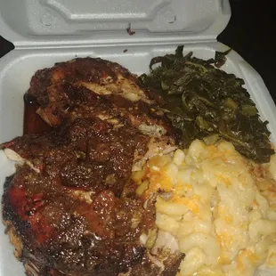 Jerk chicken with mac and cheese and greens