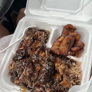 Jerk chicken rice beans gravy and plantain.
