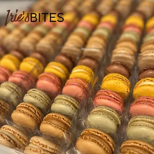 a variety of macarons in a display case