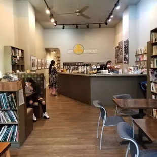 Various shelves spread out across the cafe and places to get work done in front and at the back of the cafe