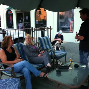 a group of people sitting on a patio