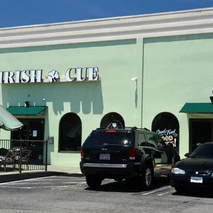 two cars parked in front of a restaurant