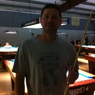 a man standing in a pool hall